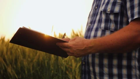 Farmer signs the document and shakes hands with partner Stock Footage 121559986