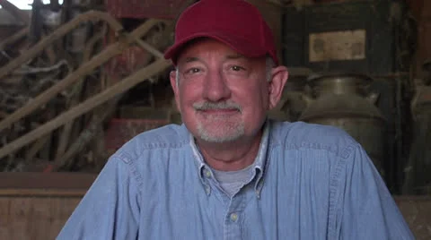 Farmer sitting in a barn, close up Stock Footage 25199495