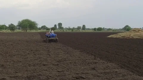 Farmer sowing seeds with automatic seed cum fertilizer drill machine Stock Footage 77572644