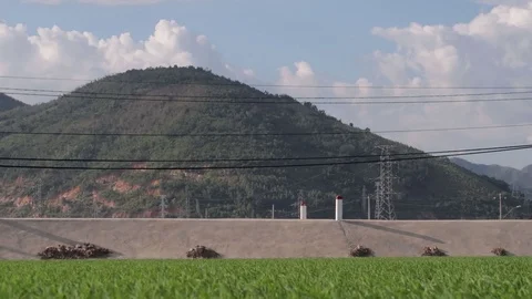 A farmer sows rice with a view of the mountains and sky. Stock Footage 118642016