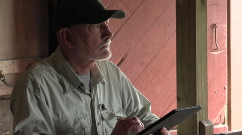 Farmer in  a stable using tablet Stock Footage 50775323