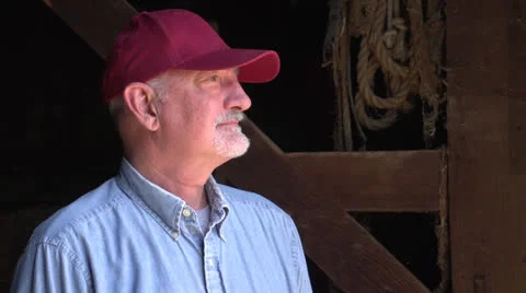 Farmer standing in a barn Stock Footage 25198967