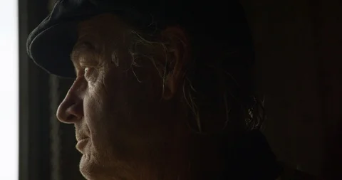 A farmer stares out at the rain. 스톡 동영상 88373761