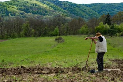 A farmer with a straw hat is taking a break after a hard work 写真素材