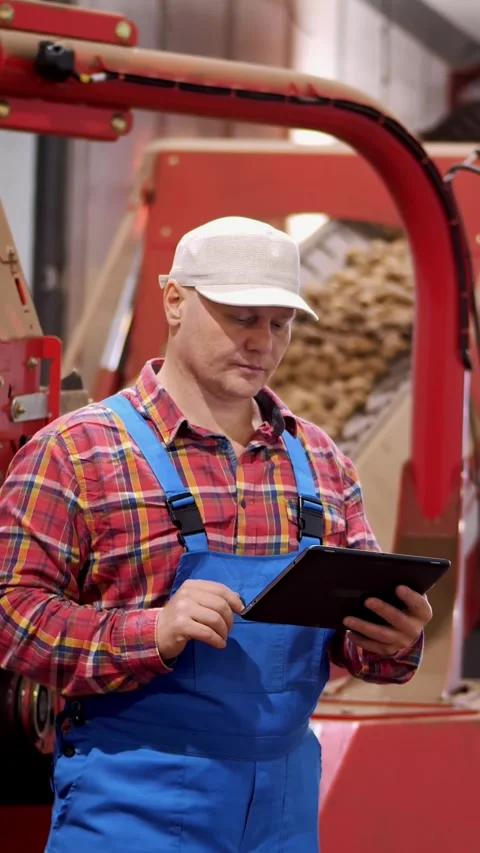 Farmer with tablet in potato storage warehouse. background of loading potatoes Video stock 312800760
