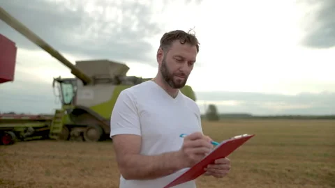 A farmer with a tablet for taking notes stands Stock Footage 250950710