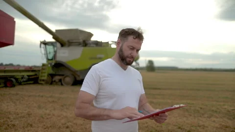 A farmer with a tablet for taking notes stands Stock Footage 250950814