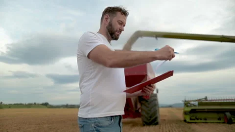A farmer with a tablet for taking notes stands Stock Footage 250950937