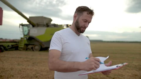 A farmer with a tablet for taking notes stands Stock Footage 250950942