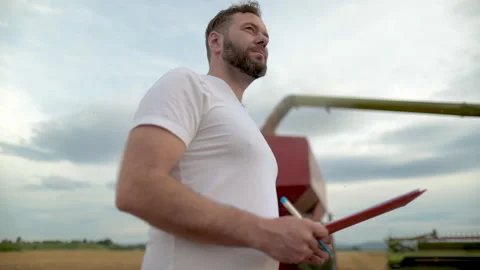 A farmer with a tablet for taking notes stands Stock Footage 250951048