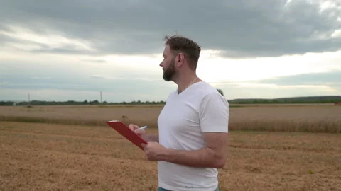 A farmer with a tablet for taking notes stands Stock Footage 250951282