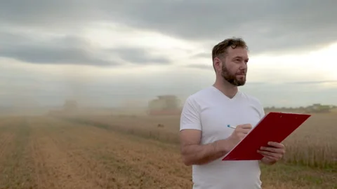 A farmer with a tablet for taking notes stands Stock Footage 250952469