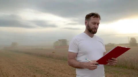 A farmer with a tablet for taking notes stands Stock Footage 250952660