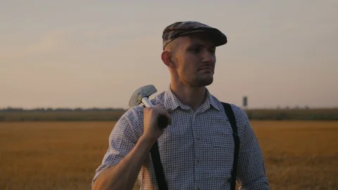 A farmer throws a shovel on his shoulder Stock Footage 113178040