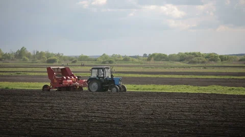 Farmer in tractor and people preparing land for sowing. Stock Footage 50803630