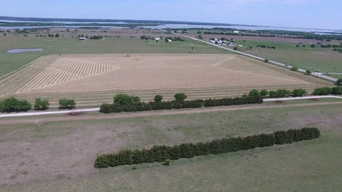 Farmer on tractor cutting hay to make hay bails. Stockbeeldmateriaal 89108706