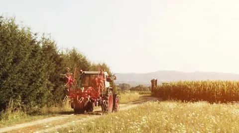 Farmer in tractor driving to the field Stock Footage 10586477