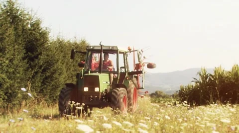 Farmer in tractor driving to the meadow Stock Footage 10586468