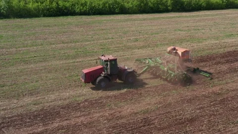 The farmer on the tractor is engaged in mechanical soil processing. Optimization Stock Footage 154345746