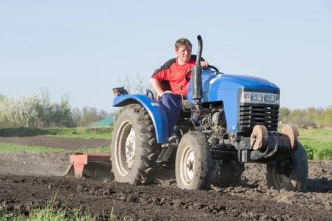 Farmer on the tractor Stock Photos