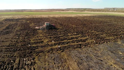 Farmer on a tractor prepares the land using a seeder-cultivator, agribusiness Stock Footage 130565771