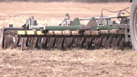 Farmer in tractor preparing land with seedbed cultivator Stock Footage 231742456