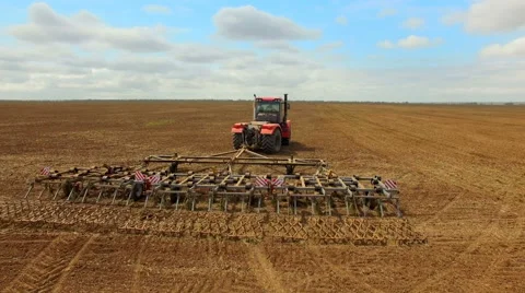 Farmer in tractor preparing land for sowing, agricultural work plowing land on a Video stock 62763714