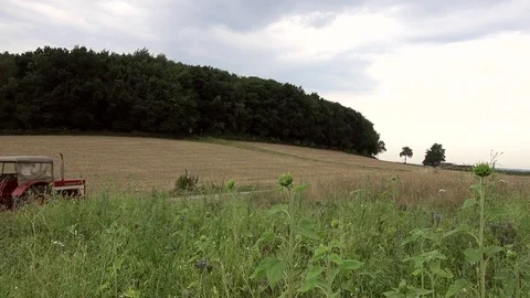 The farmer on the tractor is riding the field Stock Footage 92587910