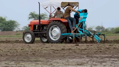Farmer in tractor seeding cottons at  farm Video stock 237743390