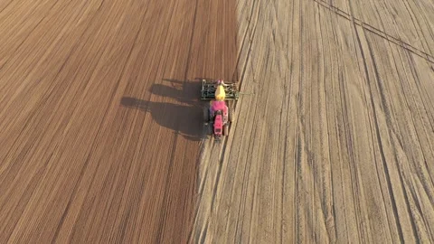 Farmer tractor seeding field with tractor and seed drill Stock Footage 312453539