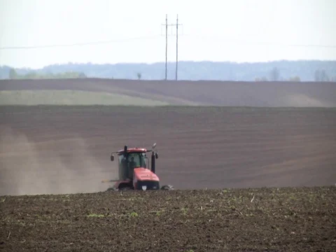 Farmer with tractor seeding Stock Footage 85124492