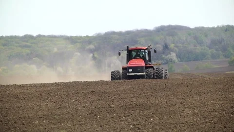 Farmer with tractor seeding Stock Footage 85498646