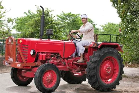 Farmer on a tractor smiling Stock Photos