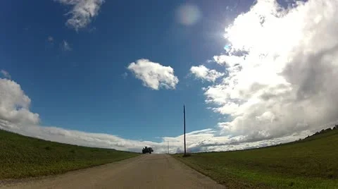 Farmer on tractor waves, driving by fields on midwestern country road Stock Footage 22322546