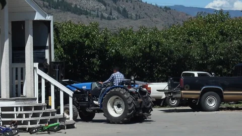 Farmer on a tractor working Stock Footage 100046944