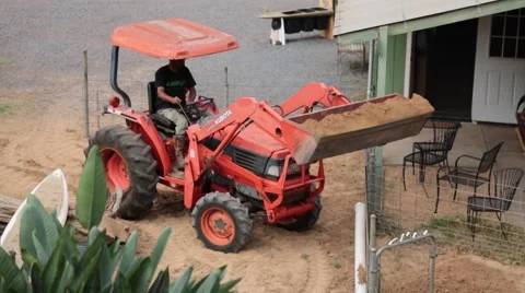 Farmer unloading sand into barn tractor Stock Footage 57464026