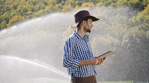 Farmer using digital tablet during monitoring his plantation. Stock Footage 99837193