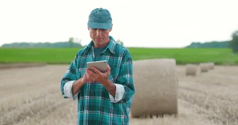 Farmer using digital tablet while examining farm Stock Footage 102393163