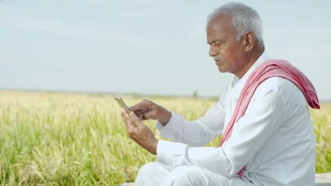Farmer using mobile phone in field Stock Footage 143839166