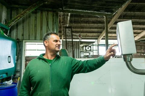 Farmer using modern technology in dairy farm management Stock Photos
