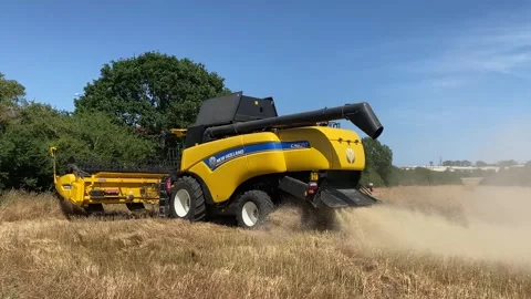 Farmer using a New Holland CX890 combine harvester to reap the fields. Stock Footage 338325786