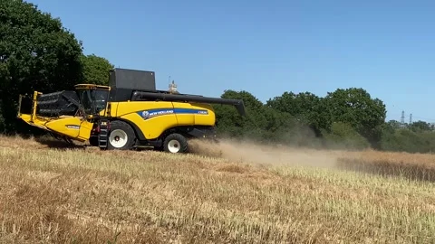 Farmer using a New Holland CX890 combine harvester to reap the fields. Stock Footage 338326076