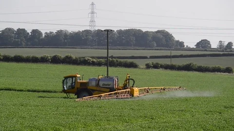 Farmer using sprayer machine to treat crops leeds yorkshire united kingdom Stock Footage 76988641