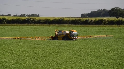 Farmer using sprayer machine to treat crops leeds yorkshire uk Stock Footage 76989066