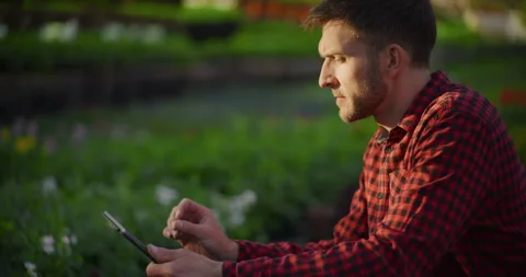 Farmer Using Tablet for Irrigation Control in Garden Farm Stock Footage 308132109