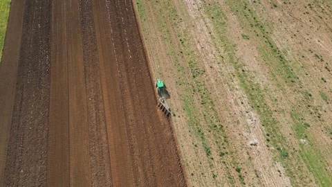 A farmer using a tractor and other farming Stock Footage 240289133