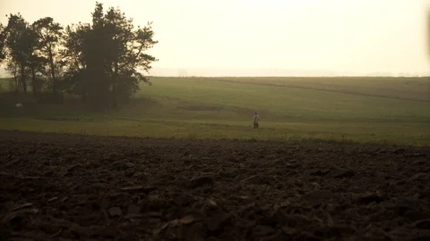 Farmer walking back home from the fields, at end of the day at magic 库存影片 100837600