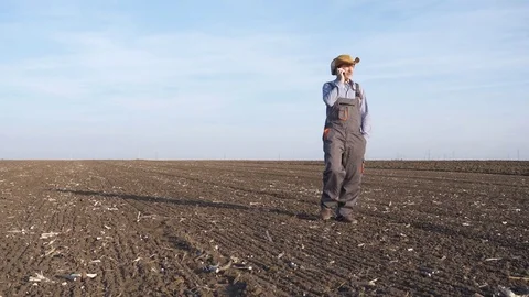 The farmer is walking on a field soil Stock Footage 82367642