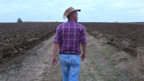 Farmer walking at his plowed fields Stock Footage 159996376
