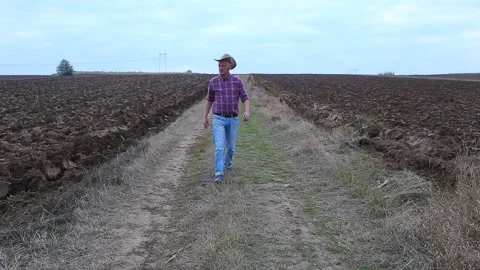 Farmer walking at his plowed fields Stock Footage 159996396